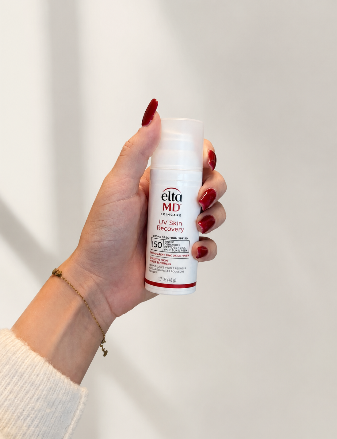 Hand holding Elta MD sunscreen at L&P Skin Shop